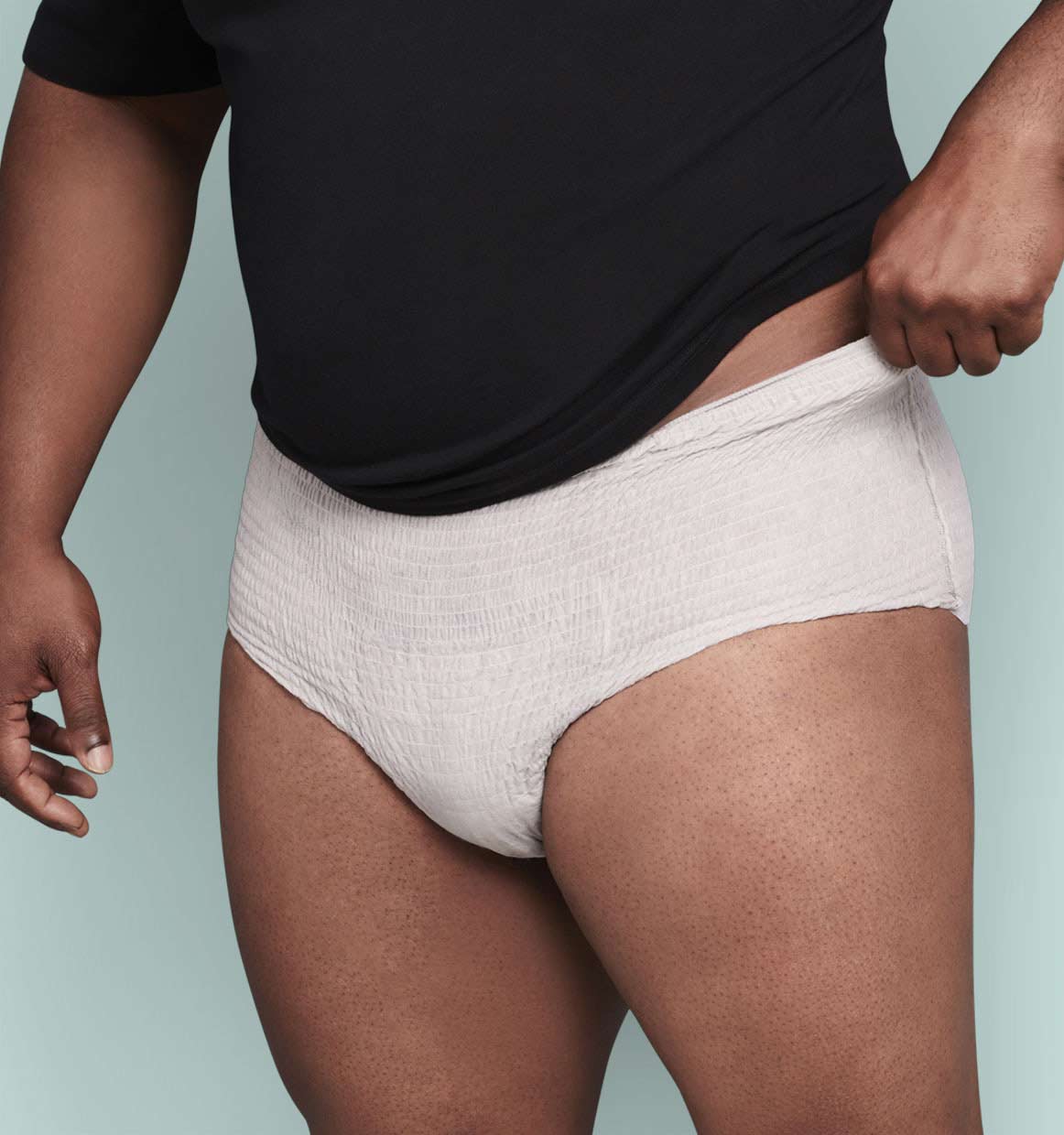Model Wearing Depend® Incontinence Fresh Protection™ Plus+ Underwear for Men